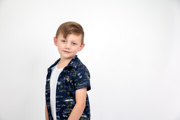 
Five-year-old model with blue print shirt, half body, posing for the photo.