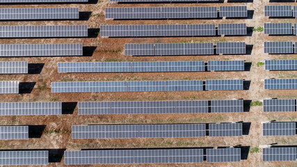 Solar panels farm on the desert aerial view from above. Alternative energy, ecology power conservation concept.  - 399419260