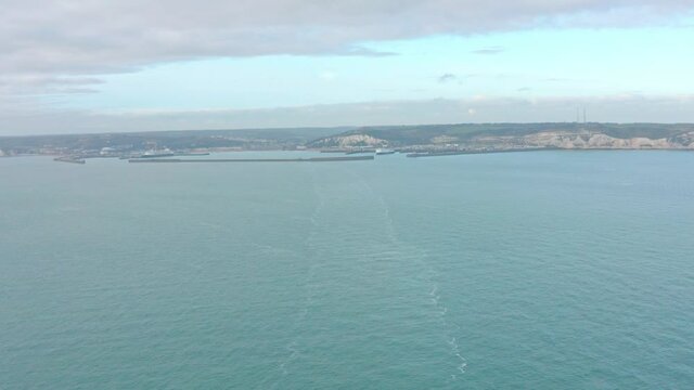 Wide aerial shot from the sea of ferry leaving Dover harbour