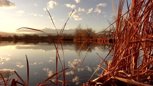Reflection of sunset and clouds over lake surface
