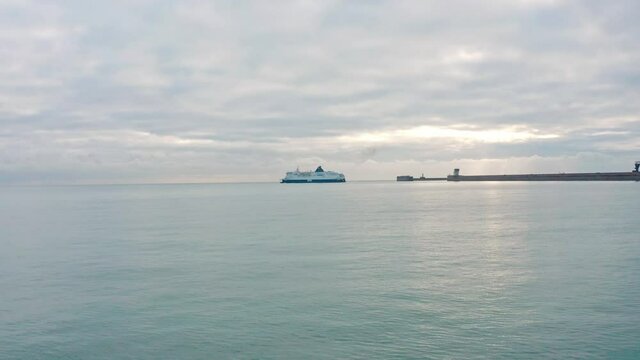 Low aerial drone shot towards Dover to calais cross channel ferry leaving dover harbour