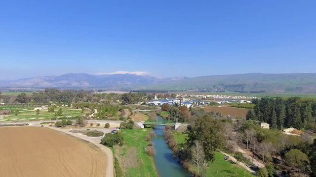 jordan river with hermon mountain in background from a drone view