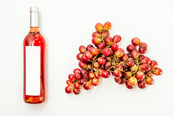 bottle of claret wine with bunches of red grapes