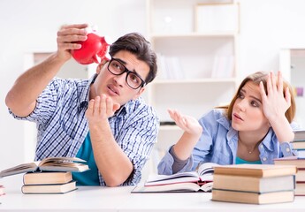 Two students checking savings to pay for education