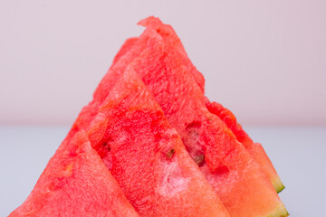 triangular watermelon pieces on pastel background
