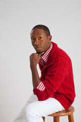 Handsome Black man sitting and looking pensive