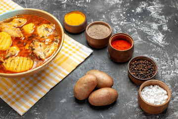 Side view of chicken soup potatoes and spices set