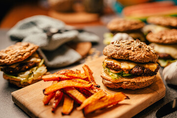 Homemade low carb diet hamburger with seed flour buns and pumpkin fries.Diet burgers with...