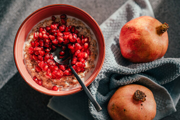 Homemade low carb diet almond and coconut flakes porridge with red pomegranate seeds.Morning...