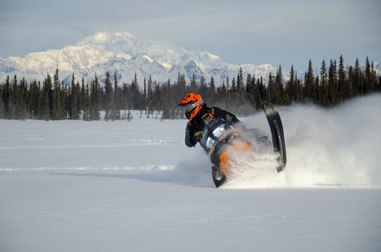 Snowmachine rider "Sledder" in front of Denali Mountain, Alaska
