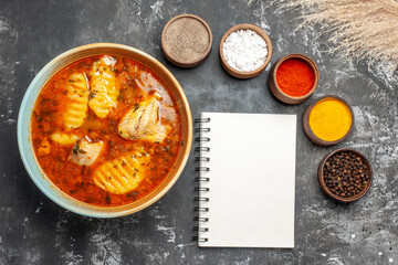 Dinner meal with chicken variety of spices and notebook horizontal view