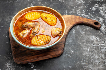Horizontal view of tomato chicken dish on cutting board