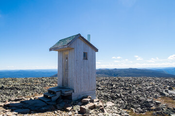 View of a wooden toilet hut at the summit of the mount Jacques Cartier in the Gaspésie national park, Canada