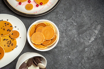 top view yummy little pancakes with choco cookies on a dark background dessert sweet cake