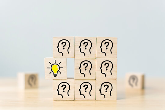 Concept creative idea and innovation. Wooden cube block with head human symbol and light bulb icon