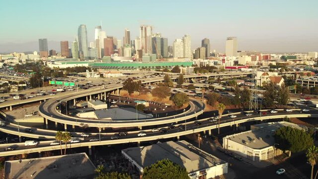 Los Angeles city skyline with light freeway traffic, push in drone