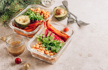 Vegan healthy meal prep containers. Chickpeas, sweet potatoes, arugula, radish and avocado for lunch