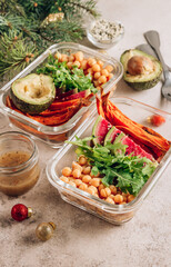 Vegan healthy meal prep containers. Chickpeas, sweet potatoes, arugula, radish and avocado for lunch