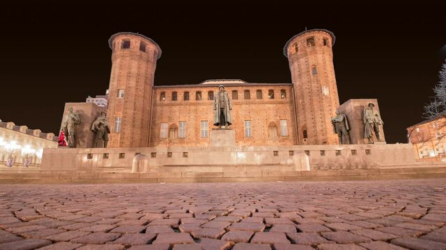 Celebratory fireworks for new year over Acaja castle of Turin, Italy. It is possible see medieval stone bricks tower during last night of year. Christmas atmosphere