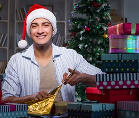 Man with many christmas gifts in boxes