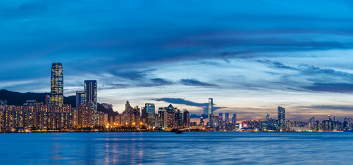 Naklejka premium Panorama of Victoria harbor of Hong Kong city at dusk