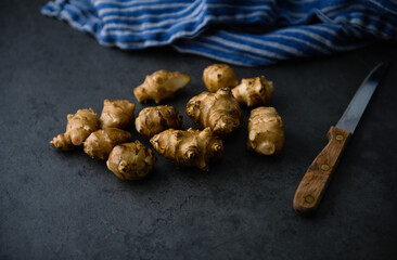 Close up of Fresh Jerusalem Artichokes on Dark Table