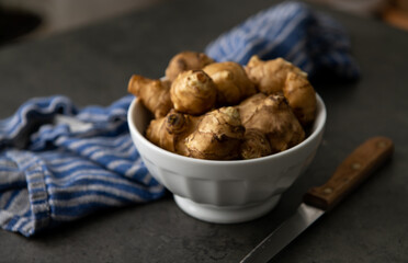 Close up of Fresh Jerusalem Artichokes on Dark Table