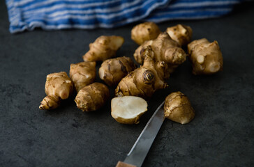 Close up of Fresh Jerusalem Artichokes on Dark Table