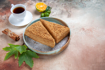 front view yummy honey cake with tea on a light background sugar biscuits sweet cake
