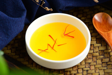 Close-up pictures of traditional Chinese medicine saffron tea on the background of retro Chinese...
