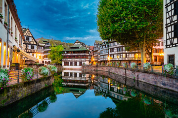 Old town water canal of Strasbourg at dusk, Alsace, France. Traditional half timbered houses of Petite France