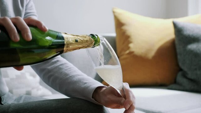 Man pouring sparkling wine into a glass
