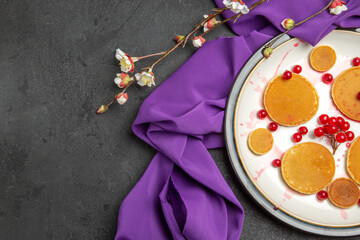 top view yummy little pancakes with red berries on a dark background fruit sweet dessert