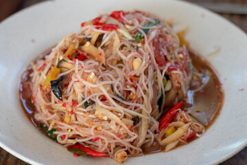 Som Tam Thai. Thai spicy green papaya salad with glass noodles