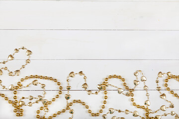 Christmas decoration from yellow shiny beads on a white background. Flatlay. New Year concept.