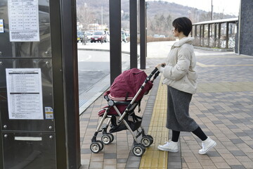 バス停でバスを待つ妊婦の女性