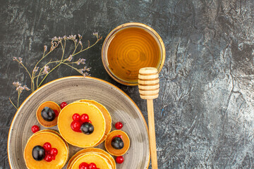 Tasty breakfast with buttermilk pancakes and honey