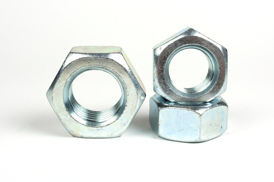large nuts made of silver metal on a white background
