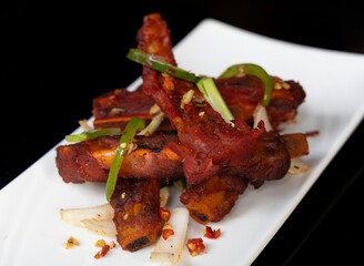 Salt and chili pork spare ribs with peppers, onions and garlic