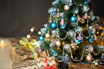 Christmas tree in Golden and blue decorations. Different shades of gold. Gift boxes. Close up. Macro photo. Holiday. Happy Christmas. Side.