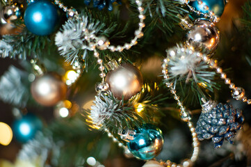 Obraz na płótnie Canvas Christmas tree in Golden and blue decorations. Different shades of gold. Gift boxes. Close up. Macro photo. Holiday. Happy Christmas. Side.