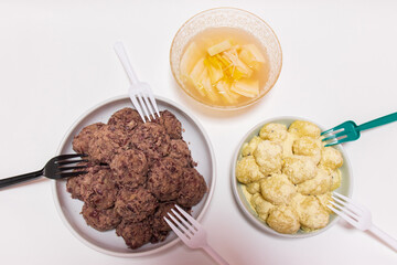 Rice cakes made with bean flour and mashed adzuki beans, Watery Kimchi (mulgimchi, mulkimchi), Korean traditional food, dessert, Injeolmi, tteok, homemade food.