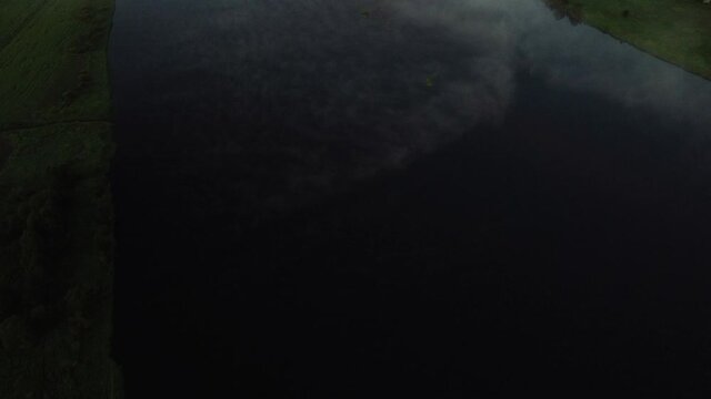 Thick fog covering Tornio river and its flood plains, lapland region, Finland, tilt up 