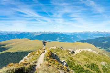 Tourist hiking Seceda peak in Dolomites. Italy