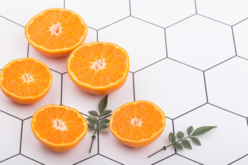 Tangerine cut in half on a white background.