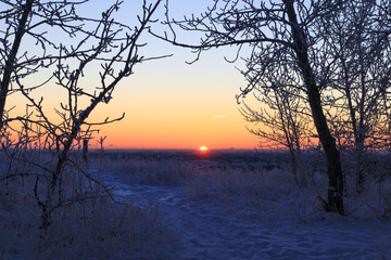 Scenic view of the sun rising on a snowy morning