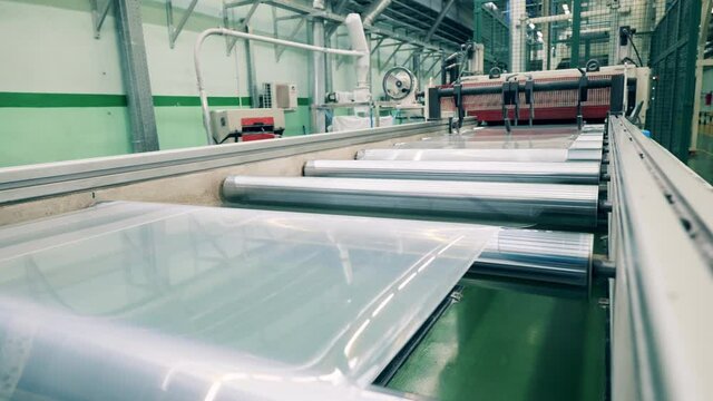 Plastic film unreeling for plastic ware manufacturing
