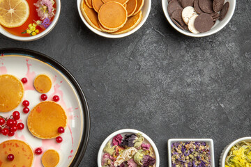 top view yummy pancakes with cup of tea on dark floor sweet pie dessert cake