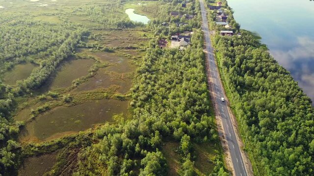 Solo traveling on long Empty highway along Tornio river, Finnish Swedish border