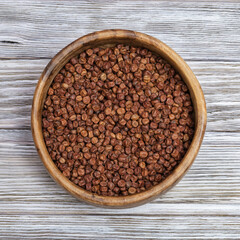 Raw gray peas in round wooden bowl on light wood. Organic healthy diet food. Traditional Latvian product.